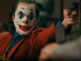 Joaquin Phoenix as Joker with a gun