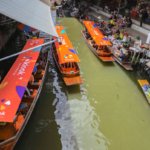 image of tourist boats in the floating market in Bangkok Thailand