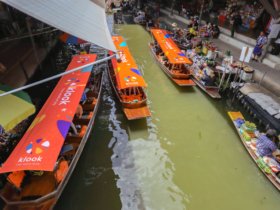 image of tourist boats in the floating market in Bangkok Thailand