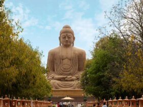 Tourists walking near the great Buddha statue in Bodh Gaya, India.