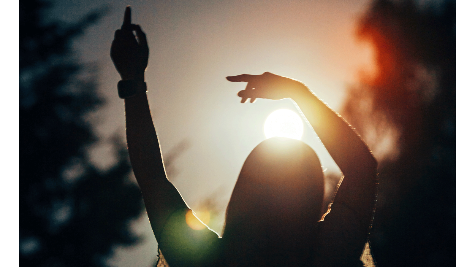 Silhouette of a woman standing outside as the Sun lowers as she contemplates her weekly horoscope for September 14-20, 2025