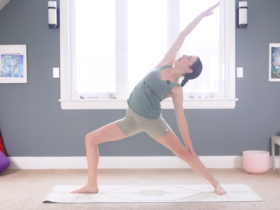 Woman in Reverse Warrior facing the long side of a mat and reaching her right arm alongside her head