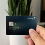 Nomadic Matt holding up his Capital One Venture X card