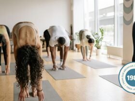 Image of yoga class practicing standing forward bend.