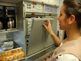 Flight Attendant using the oven onboard